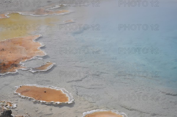 Hot spring with colorful, natural geology consisting of orange and blue, Yellowstone National Park, Wyoming, USA