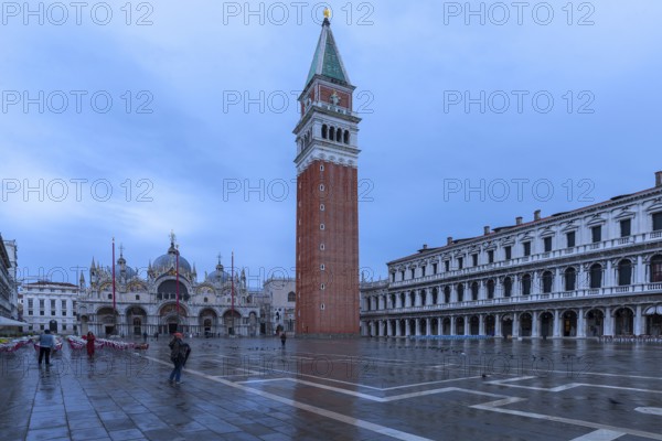 Empty St. Mark's Square with arcades of the Old Procuration, 16th century and St. Mark's Basilica early in the morning in rainy weather, Venice, Veneto, Italy