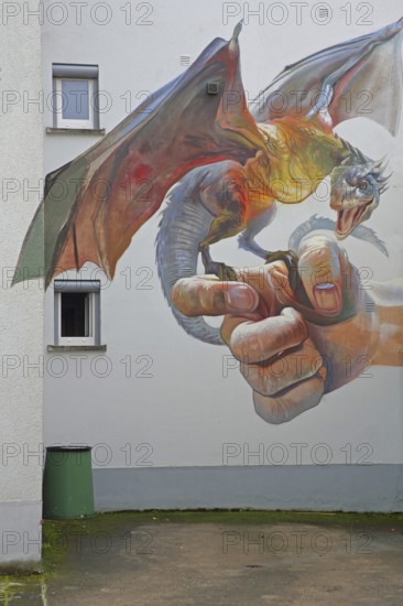 Mural Game of Thrones by CASE maClaim 2016, holding a dragon, fingers, street art, graffiti, Bad Vilbel, Wetterau, Hesse, Germany