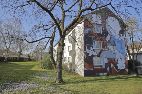 Mural by CASE MacAclaim and Millo, street art, graffiti, child carrying house in hands, illustration, comic, airplane, carrying, row house, spring, Andreas von Chrzanowski, Francesco Camillo Giorgino, Bad Vilbel, Wetterau, Hesse, Germany