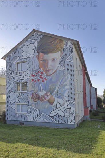 Mural by CASE MacAclaim and Millo 2023, street art, boy with apple tree in hands, protecting, apples, fruits, care, airplane, black and white illustration, photorealistic graffiti, houses, urban residential area, row house, Andreas von Chrzanowski, Francesco Camillo Giorgino, Bad Vilbel, Wetterau, Hesse, Germany