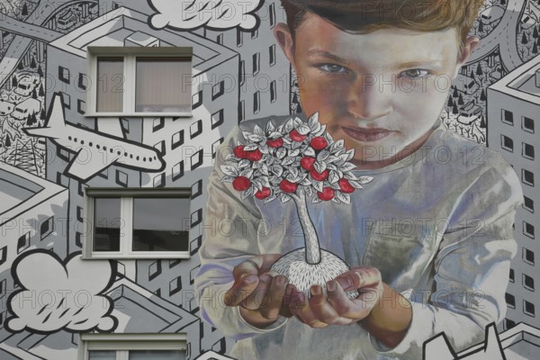 Mural by CASE MacAclaim and Millo 2023, street art, boy carrying apple tree in hands, protecting, apples, fruits, care, airplane, black and white illustration, photorealistic graffiti, houses, urban residential area, Andreas von Chrzanowski, Francesco Camillo Giorgino, Bad Vilbel, Wetterau, Hesse, Germany