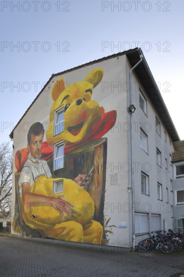 Mural Waldsterben by CASE MaClaim 2024, man with yellow plush toy, bear figure, street art, photorealistic graffiti, row house, symbol, Bad Vilbel, Wetterau, Hesse, Germany