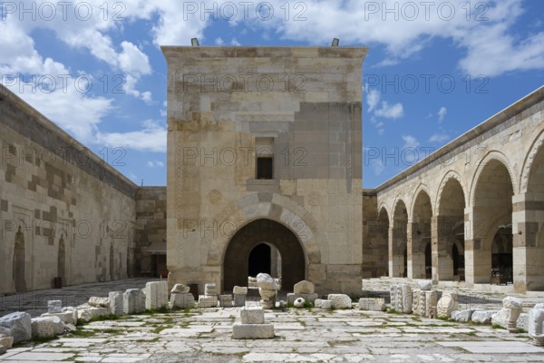 Old courtyard with stone arches and scattered ruins under a clear sky, Sultanhani caravanserai, on the former Silk Road, museum, Sultanhani Kervansaray, Sultanhani, Aksaray province, Turkey