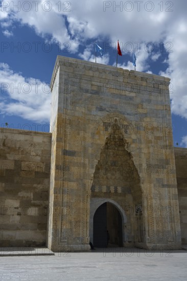 Decorated medieval gate in a high stone wall under a clear sky, richly decorated portal of the Sultanhani caravanserai, on the former Silk Road, museum, Sultanhani Kervansaray, Sultanhani, Aksaray province, Turkey