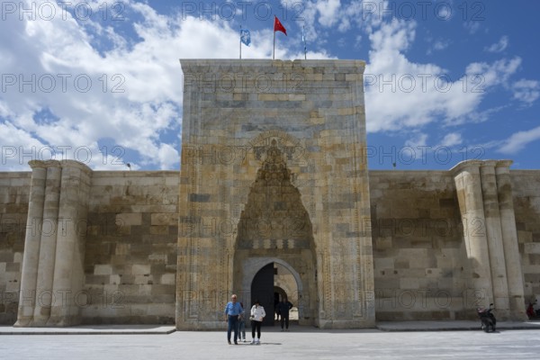 Detailed historic gate with stone walls and people in the foreground, richly decorated portal of the Sultanhani caravanserai, on the former Silk Road, museum, Sultanhani Kervansaray, Sultanhani, Aksaray province, Turkey