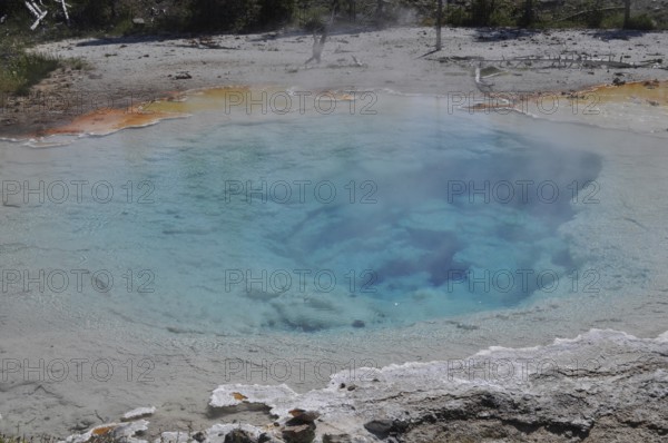 Close-up of a hot spring with clear blue water and steam, Yellowstone National Park, Wyoming, USA