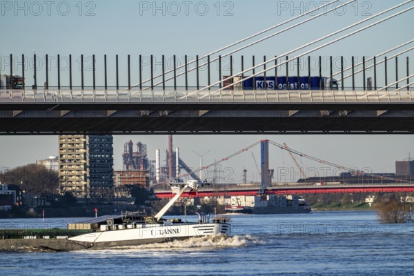 Shipping on the Rhine near Duisburg-Homberg, new A40 motorway bridge, Neuenkamp Rhine bridge, first construction phase, Friedrich-Ebert bridge between Homberg and Ruhrort in the back, industrial setting of the ThyssenKrupp steel plant, North Rhine-Westphalia, Germany