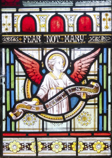 Details of stained glass window of an angel by Clayton and Bell, church of Saint James, Avebury, Wiltshire, England, UK