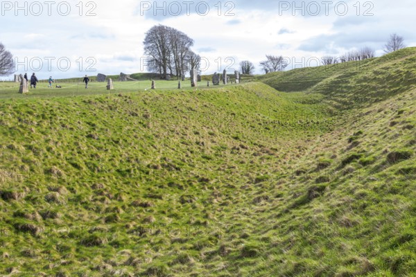 Earthwork bank and ditch, standing stones of prehistoric henge and stone circle, Avebury, Wiltshire, England, UK