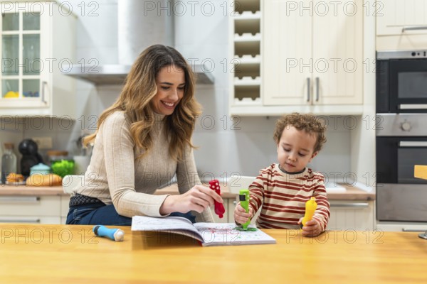 Mother and son coloring together at the kitchen table, sharing a joyful, candid moment of creativity, learning and bonding in bright natural light at home