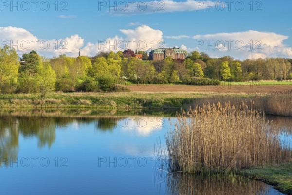 View of a small lake at Burgscheidungen Castle in evening light in spring, Unstrut Valley, Burgenlandkreis, Saxony-Anhalt, Germany