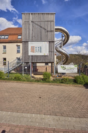 Kindergarten, slide, St. Michael Catholic Kindergarten, building, modern architecture, parking boxes, metal fence, shrubs, trees, blue sky, cumulus clouds, cirrus clouds, Hoffuhre, Untere Forststraße, Waldaschaff, Lower Franconia, Aschaffenburg district, Bavaria, Germany