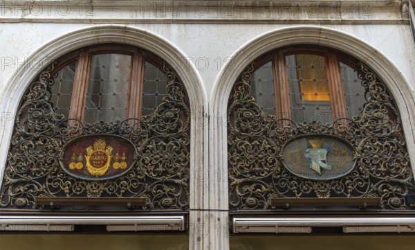 Artfully forged window grilles at the branch of the Wiener Habig Hutfabrik, since 1882 in Venice, Veneto, Italy