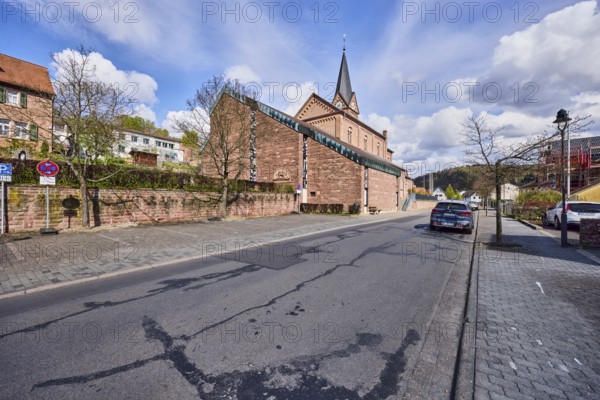 St. Michael church, sandstone wall, general architecture, houses, lantern, parking strips with car, sidewalk, trees, bare winter trees, blue sky, cumulus clouds, cirrus clouds, Kirchstraße, Waldaschaff, Lower Franconia, Aschaffenburg district, Bavaria, Germany