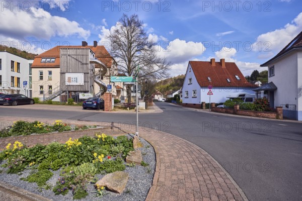 Residential development, Catholic kindergarten St. Michael, slide, roads, sidewalk, flower bed, commercial buildings, residential buildings, parking boxes with cars, bare winter tree, blue sky, cumulus clouds, cirrus clouds, intersection of Kirchstraße, Hoffuhre and Untere Forststraße, Waldaschaff, Lower Franconia, district of Aschaffenburg, Bavaria, Germany