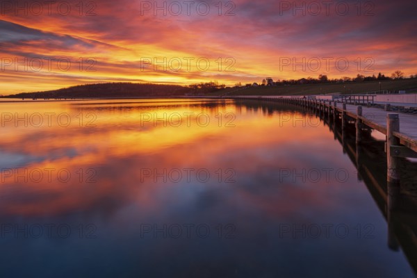 Jetty at sunrise on Geiseltalsee, artificial lake, open-cast mining lake, recultivated open-cast mine, post-mining landscape, Marina Braunsbedra, Saxony-Anhalt, Germany