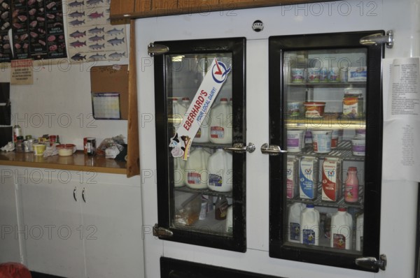 An ancient cooling rack with various drinks and food in a small shop, Mitchell, Oregon, USA