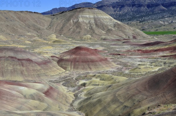 Impressive hilly landscape in natural colors, John Day Fossil Beds National Monument, Painted Hills Unit, Oregon, USA