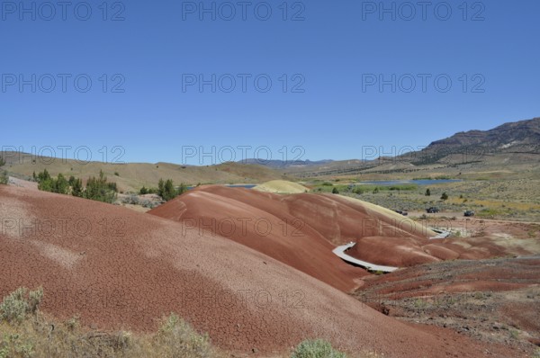 A landscape of colorful hills under a clear blue sky, John Day Fossil Beds National Monument, Painted Hills Unit, Oregon, USA