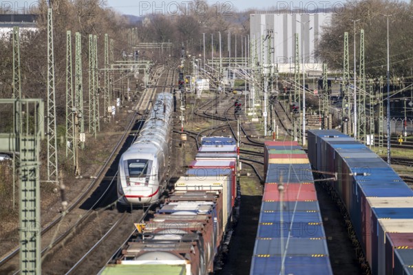 ICE long-distance train, on the line, container trains in the freight yard, so-called installation tracks in Duisburg-Rheinhausen, freight trains are parked here at short notice in front of continuing their journey, either to the trimodal terminal in Logport Duisburg or from there to distant destinations, such as China, as part of the new Silk Road, North Rhine-Westphalia, Germany