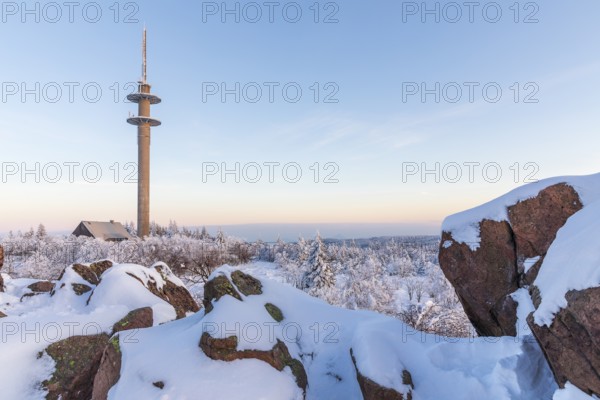 View from Großer Lugstein of the radio tower and the winter landscape with snow-covered trees and branches covered in hoarfrost on the Ore Mountains Ridge at sunset, Zinnwald-Georgenfeld, Altenberg, Eastern Ore Mountains, Saxony, Germany