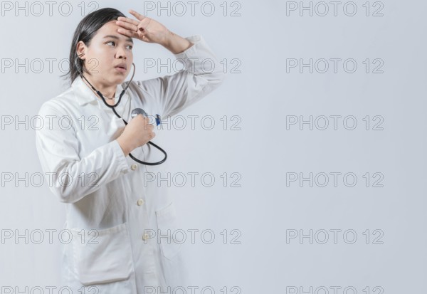 Young female doctor hearing Her Own Heartbeat with Stethoscope. Asian Female Doctor Listening to Her Own Heartbeat with Stethoscope isolated