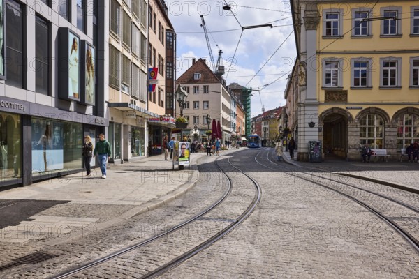 City center, general architecture, commercial buildings, shops, shopping, fashion stores, street, overhead line, tram tracks, sidewalk slabs, cobblestones, pedestrian zone, pedestrians as a secondary theme, blue sky, cumulus clouds, Augustinerstraße, Beim Grafeneckart, Würzburg, Lower Franconia, district-free city, Bavaria, Germany