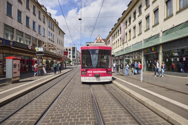 Tram, overhead lines, tram tracks, cathedral tram stop, city center, pedestrian zone, general architecture, residential and commercial buildings, pedestrians as a secondary theme, blue sky, cumulus clouds, Kürschnerhof street, Würzburg, Lower Franconia, district-free city, Bavaria, Germany