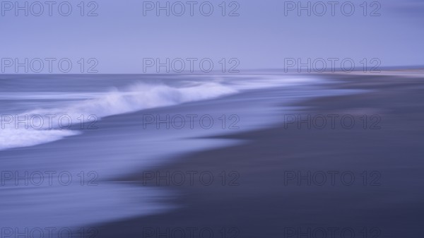 Okarito Beach in the evening with sea and sandy beach. Long exposure, blurred (ICM) . Westland Tai Poutini National Park, West Coast, South Island, New Zealand