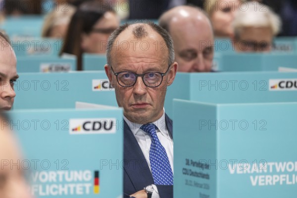 38th Federal Party Congress of the CDU of Germany in Stuttgart. Federal Chancellor Friedrich Merz has left the stage and podium and is sitting in the ranks of delegates from the state association of North Rhine-Westphalia during the election. Privacy when voting by secret ballot. Stuttgart, Baden-Württemberg, Germany