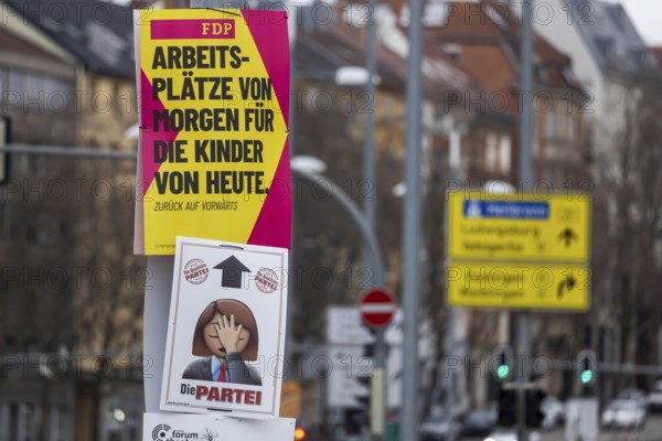 2026 state election in Baden-Württemberg. Election advertising in the city center of Stuttgart. Poster of the FDP party. Countered by a poster from THE PARTY THE PARTY. Stuttgart, Baden-Württemberg, Germany