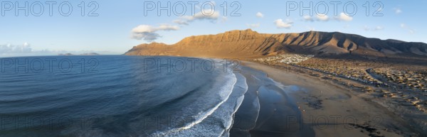 Panorama, Risco de Famara cliffs and sea with Famara beach, in the evening light, Playa de Famara, aerial view, Lanzarote, Canary Islands, Spain