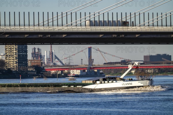 Shipping on the Rhine near Duisburg-Homberg, new A40 motorway bridge, Neuenkamp Rhine bridge, first construction phase, Friedrich-Ebert bridge between Homberg and Ruhrort in the back, industrial setting of the ThyssenKrupp steel plant, North Rhine-Westphalia, Germany