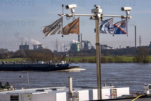 Backdrop of the HKM steelworks, Krupp-Mannesmann steel mill, blast furnaces, gasometer, coking plant extinguishing tower, fire cloud, cargo ship on the Rhine, North Rhine-Westphalia, Duisburg, Germany