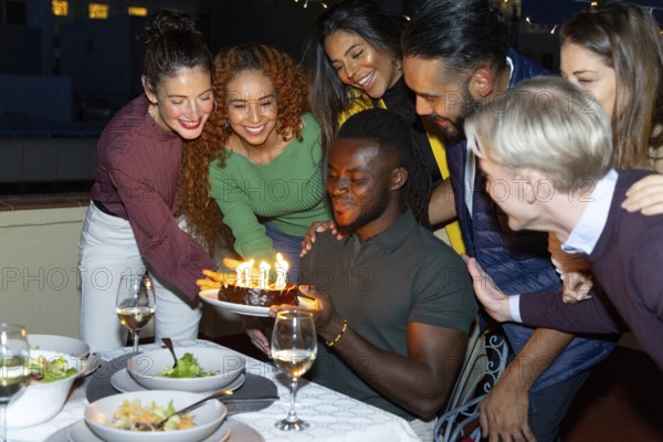 A lively group of friends celebrating a special occasion They gather around a table, smiling and laughing, enhancing the joyful atmosphere with warm lighting and festive decor