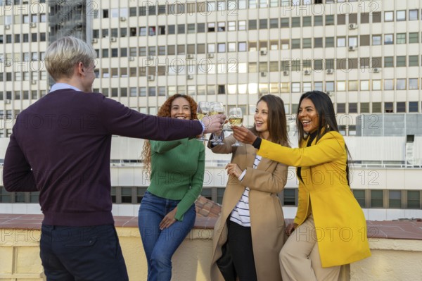 A joyful group of friends celebrating at a rooftop party, clinking glasses and smiling The festive atmosphere and urban backdrop add to the lively mood of the gathering
