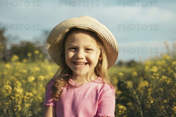 Little girl 4 years old on a flowering field in summer. Children and nature