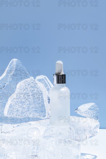 A serene image showcasing a clear serum bottle placed on an icy sculpture, illuminated with a soft blue backdrop, emphasizing freshness and purity
