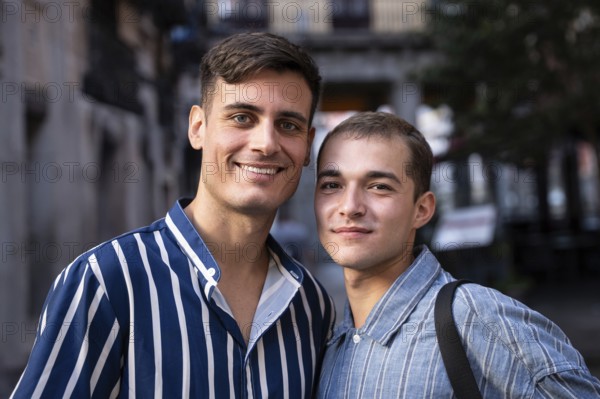 A smiling gay couple enjoys a sunny day while strolling through the lively streets of Madrid. The warm atmosphere highlights their joy and connection