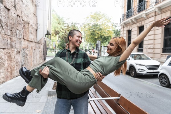 Joyful Colombian lesbian couple sharing a playful moment in the city. Celebrate love, diversity, and identity. Perfect for themes of equality, liberty, and respect