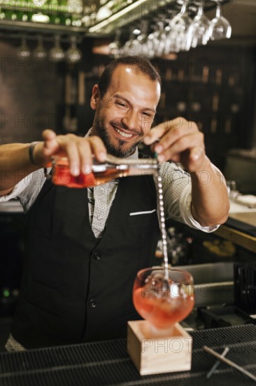 A professional bartender skillfully pours a vibrant cocktail into a glass at a stylish modern bar, showcasing expertise and creativity in mixology