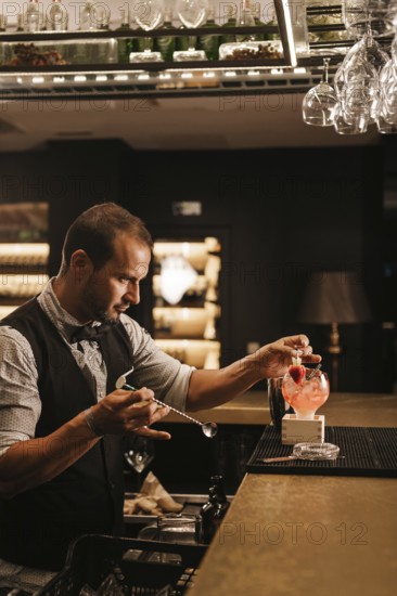 A skilled bartender expertly prepares a cocktail in a stylish bar, showcasing precision and creativity. Glasses and bottles create an inviting, vibrant atmosphere