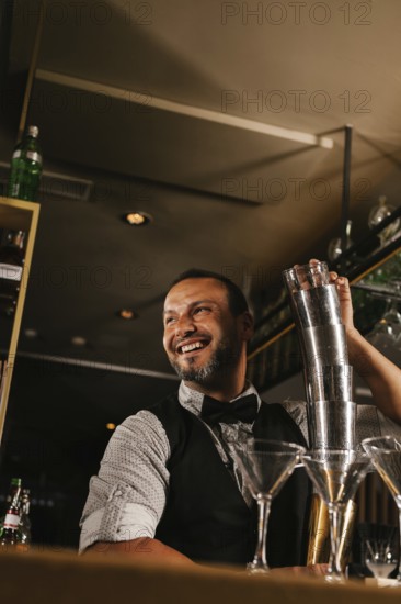 A skilled bartender joyfully mixes cocktails at an elegant bar, showcasing expertise and charm. Lined with sparkling glasses, the bar ambiance is inviting and lively