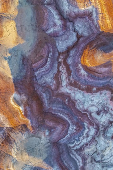 Stunning aerial view of vibrant bentonite formations in Utah, showcasing unique swirling patterns and rich earthy tones. This natural wonder highlights geological beauty