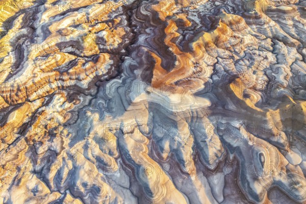 Stunning aerial view of bentonite formations in Utah. The vibrant colors and swirling patterns create a unique natural landscape, showcasing geological artistry