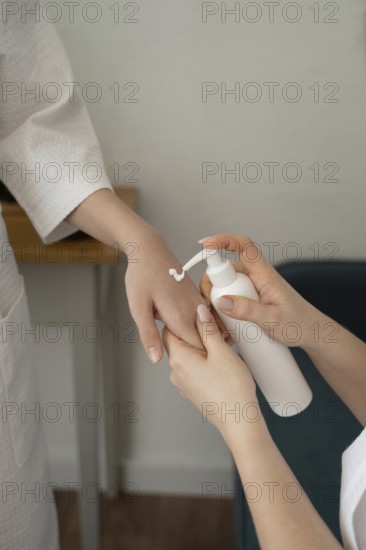 A mother and daughter engage in a relaxing skincare routine, applying lotion in a cozy home setting, emphasizing self-care, bonding, and natural beauty practices