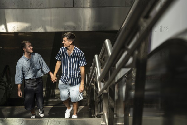 A happy gay couple, hand in hand, strolling up a stairway in the vibrant streets of Madrid. Captures a moment of joy and connection, emphasizing love and pride