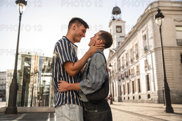 A gay couple shares a tender moment on the vibrant streets of Madrid. The sunlight enhances their happy expressions, capturing a sense of love and acceptance in an urban setting