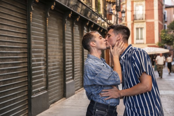 A gay couple shares a tender embrace on the vibrant streets of Madrid, reflecting love, equality, and acceptance in an urban setting, symbolizing LGBTQIA+ pride